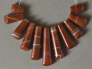 11 brown agate graduated trapezoid shaped beads.