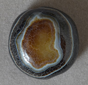 Large round bead from yellow, black, brown and white antique agate.