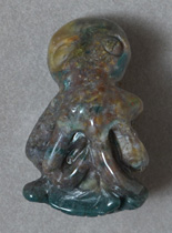 Octopus on fish carved from moss agate.