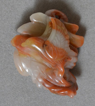 Pendant bead carving of flying bird from red agate.