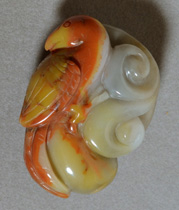 Carved bird from red and yellow agate.
