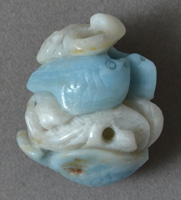 Pendant bead with carvings of fish from amazonite.
