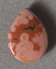 Brownish red with beige to pink ocean jasper bead.