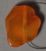 Orange queensland agate freeform pendant bead.