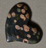 Freeform pendant bead from plumite jasper.