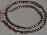 Small round beads from dark rhodonite.
