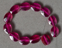 Synthetic ruby faceted oval beads.