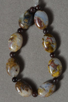 Eight brown pietersite flat oval beads.