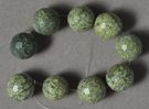Large micro faceted serpentine round beads.