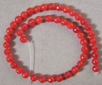 Strand of faceted red ruby round beads.