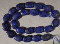 Blue flat oval beads from lapus lazuli.
