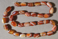 Barrel beads from red and white striped agate.