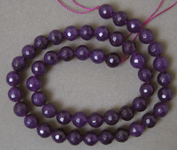 Strand of faceted round beads from purple ruby quartz.