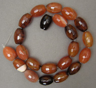 Faceted barrel beads from carnelian agate.