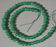 Faceted round bead strand from green jade.