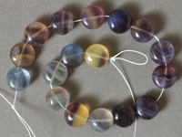 Flat round beads from rainbow fluorite.