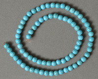Turquoise round beads with veins.
